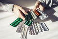 Medicine pills or capsules with old womanÃ¢â¬â¢s hands on white background with copy space. Blister pack Royalty Free Stock Photo